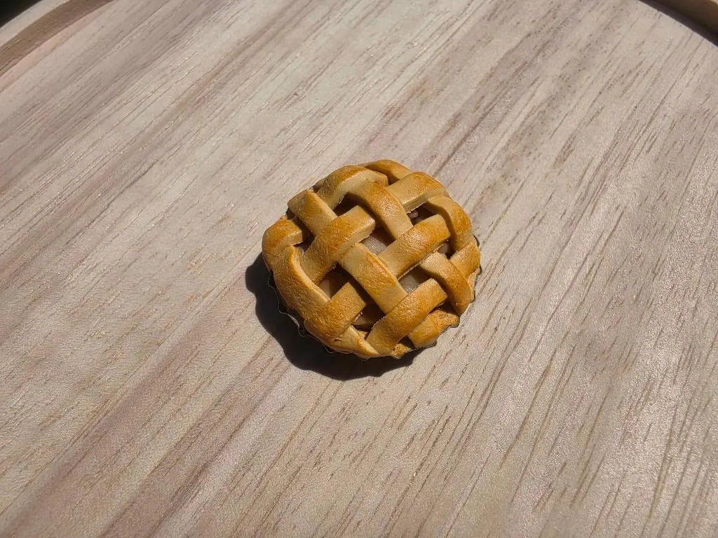 Mini lattice apple pie refrigerator magnet with a woven crust, handmade from polymer clay
