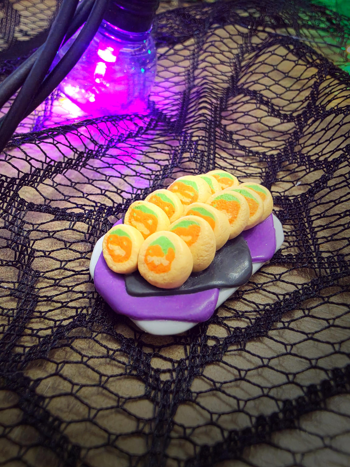 One-of-a-kind miniature pumpkin cookie platter with a dozen jack-o-lantern slice-and-bake cookies on a purple napkin, polymer clay Halloween dollhouse food