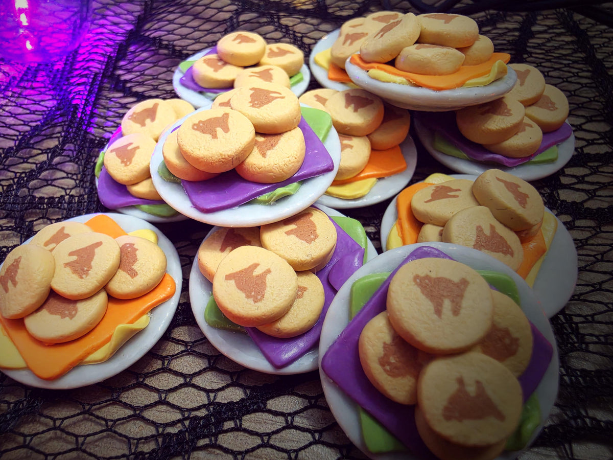 Miniature Halloween cat cookie plates with purple/green and orange/yellow napkins, polymer clay dollhouse food